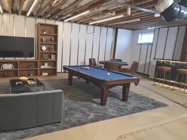 a room with furniture pool table and flat screen tv