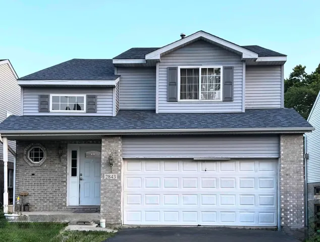 a front view of a house with garage