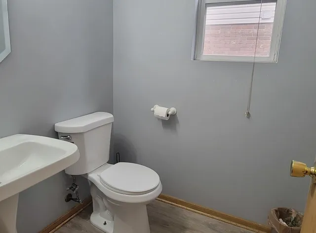 a white toilet sitting next to a bathroom sink