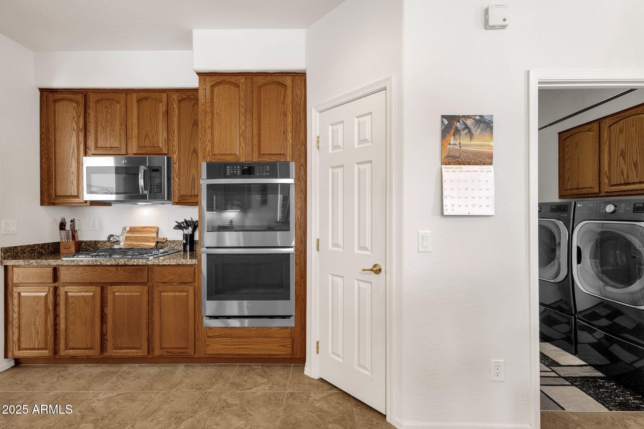 2417 West Apache Rain Road Phoenix, AZ 85085 - Photo 13 of 41 a kitchen with a refrigerator stove and a sink