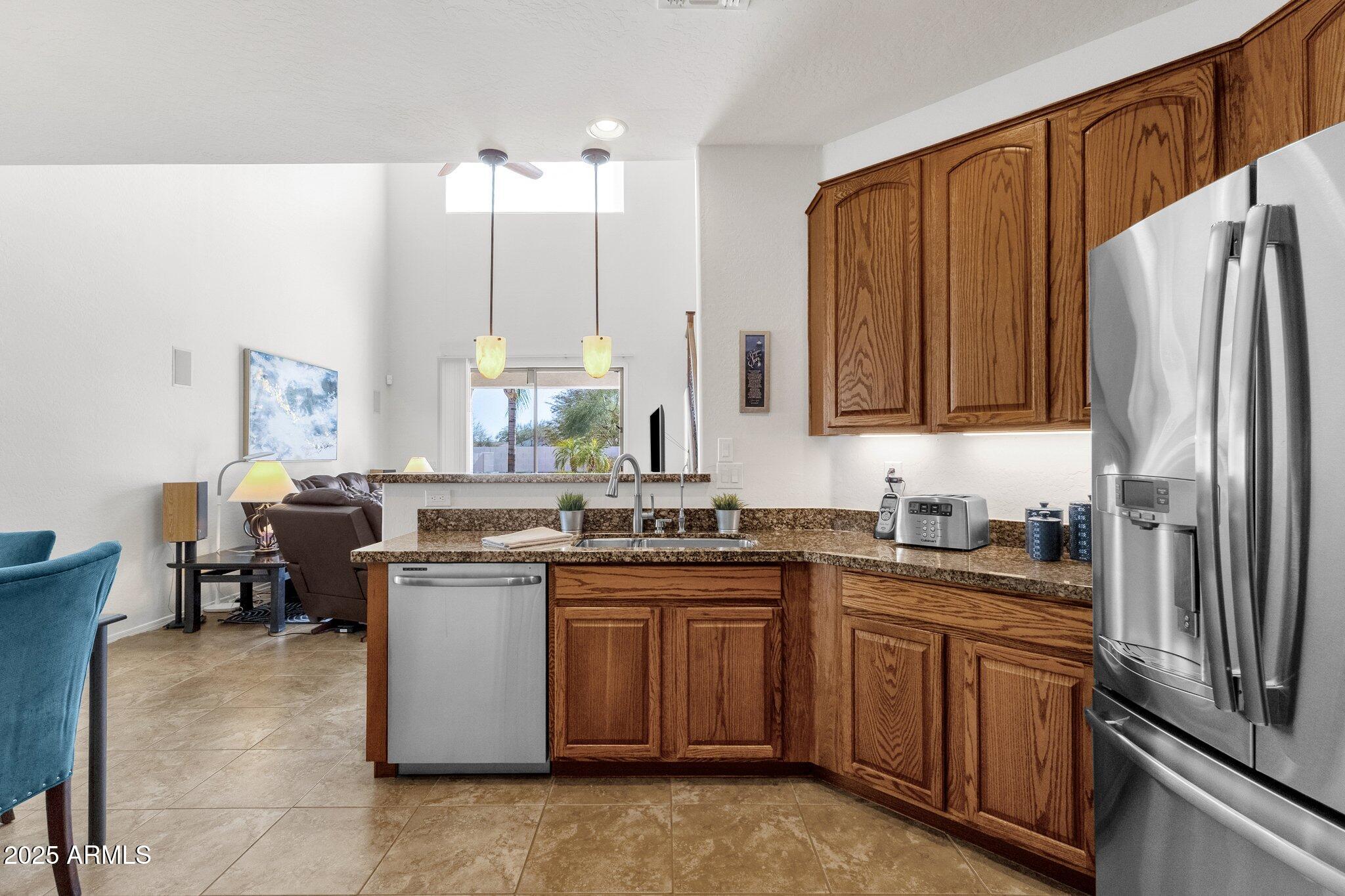 2417 West Apache Rain Road Phoenix, AZ 85085 - Photo 14 of 41 a kitchen with stainless steel appliances granite countertop a stove a sink dishwasher and a refrigerator