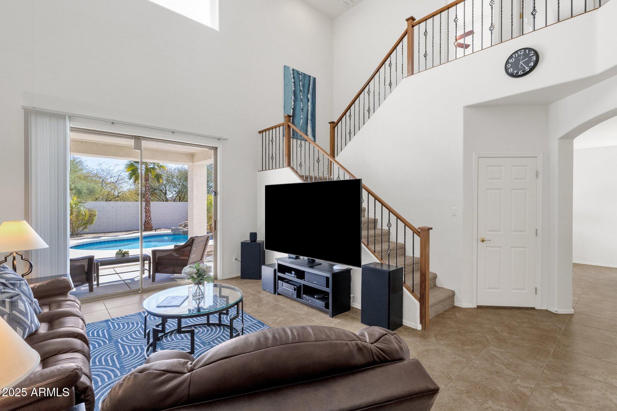 2417 West Apache Rain Road Phoenix, AZ 85085 - Photo 18 of 41 a living room with furniture and a flat screen tv