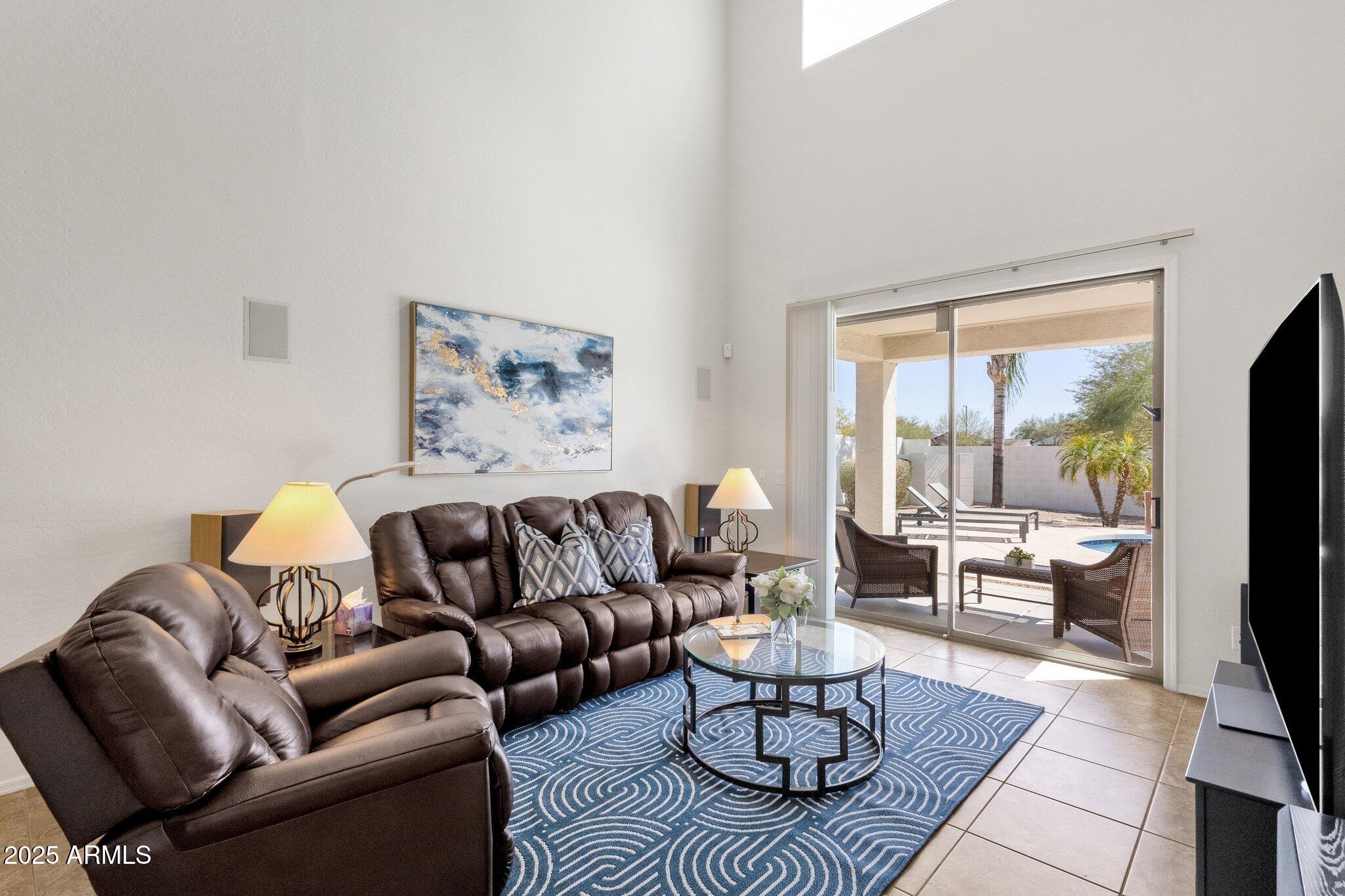 2417 West Apache Rain Road Phoenix, AZ 85085 - Photo 19 of 41 a living room with furniture couches and a flat screen tv