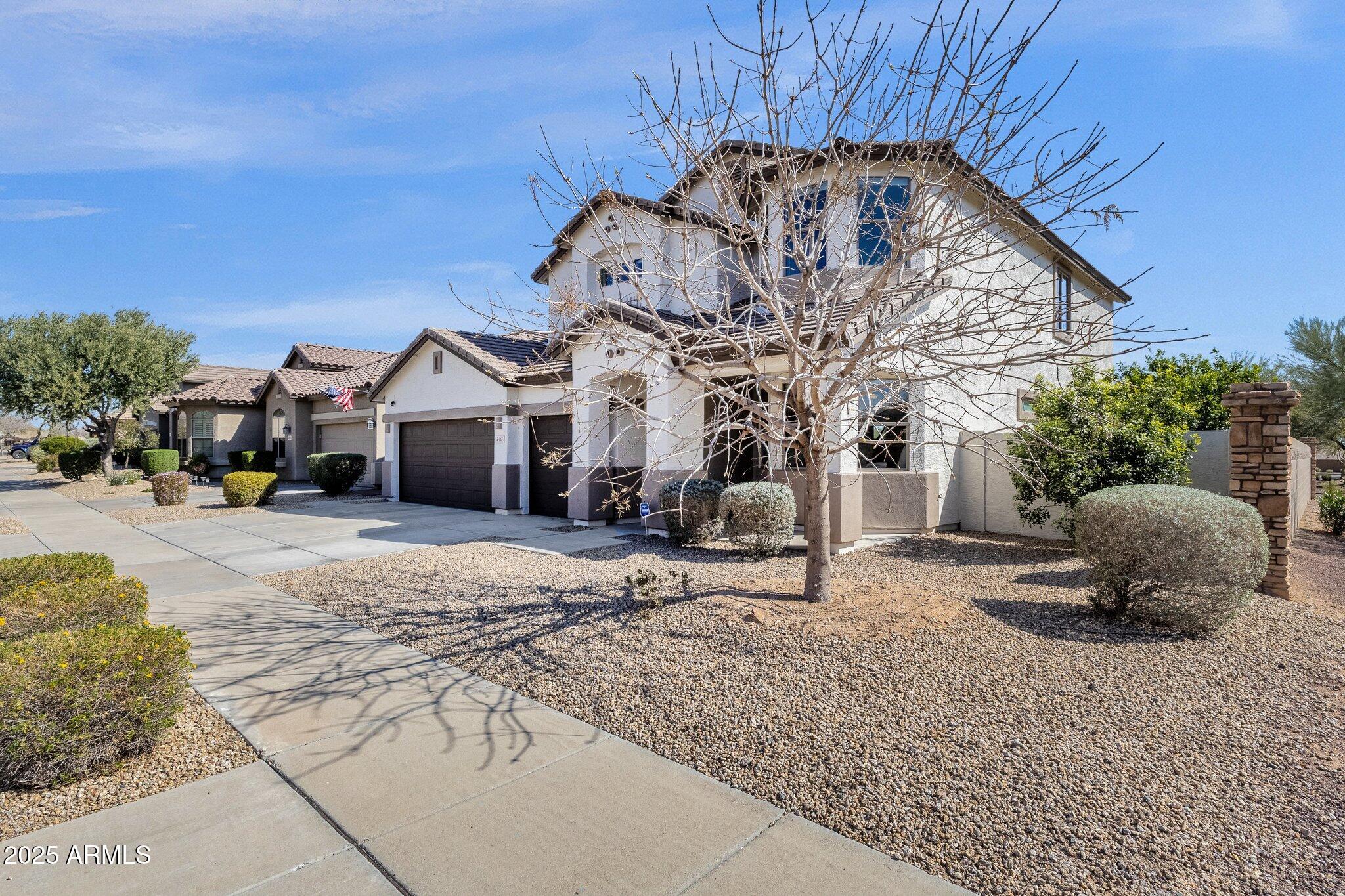 2417 West Apache Rain Road Phoenix, AZ 85085 - Photo 2 of 41 a front view of a house with cars parked