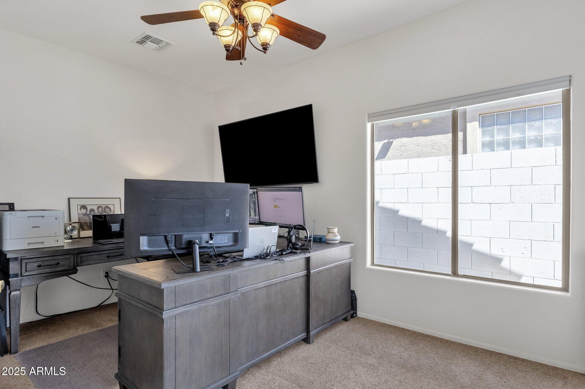 2417 West Apache Rain Road Phoenix, AZ 85085 - Photo 21 of 41 a work room with furniture and a flat screen tv