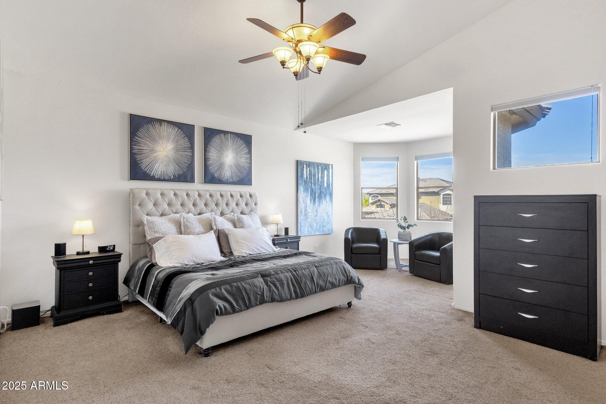 2417 West Apache Rain Road Phoenix, AZ 85085 - Photo 22 of 41 a bedroom with a bed and a chandelier