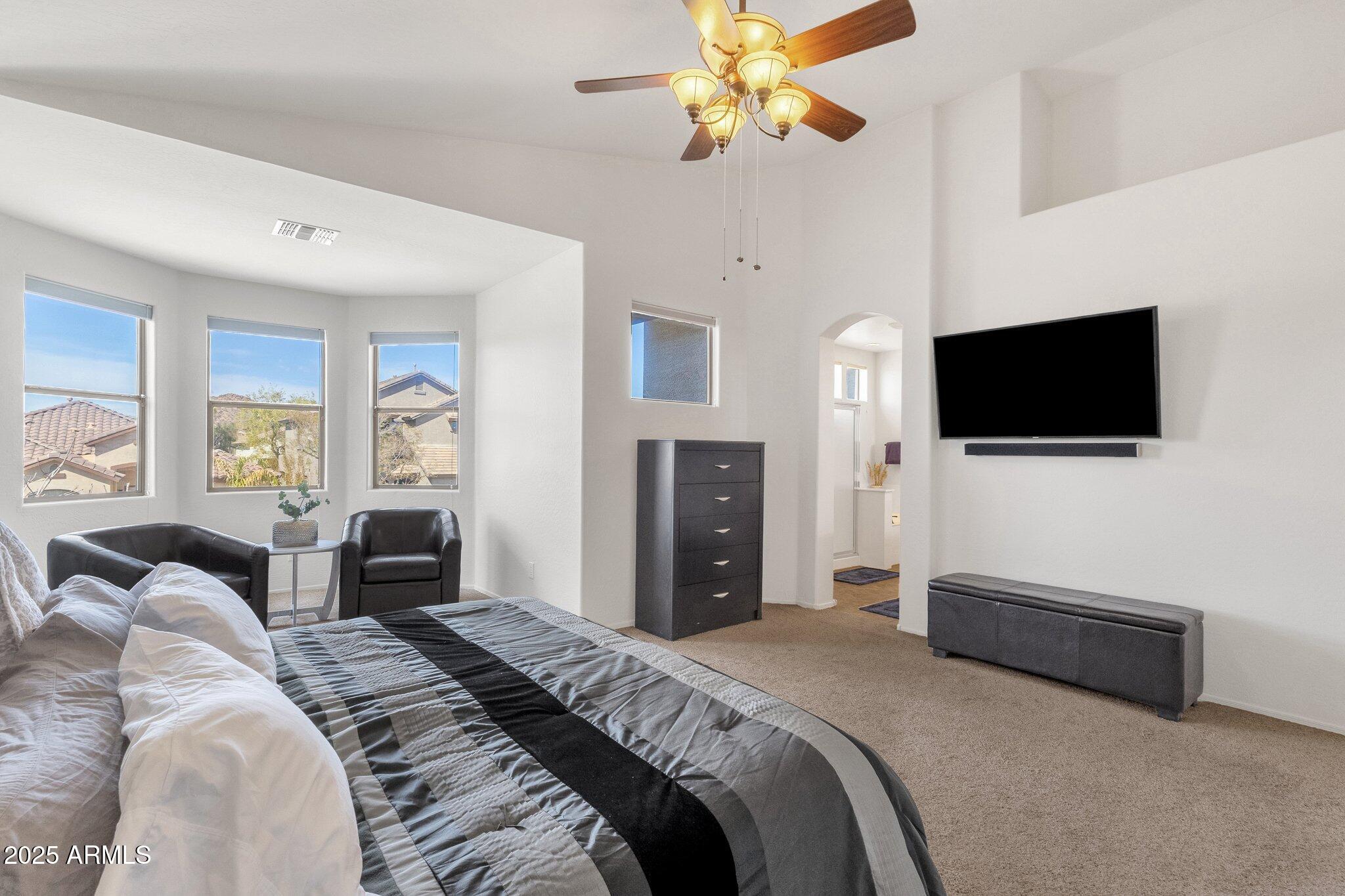 2417 West Apache Rain Road Phoenix, AZ 85085 - Photo 23 of 41 a bedroom with a bed and a flat screen tv