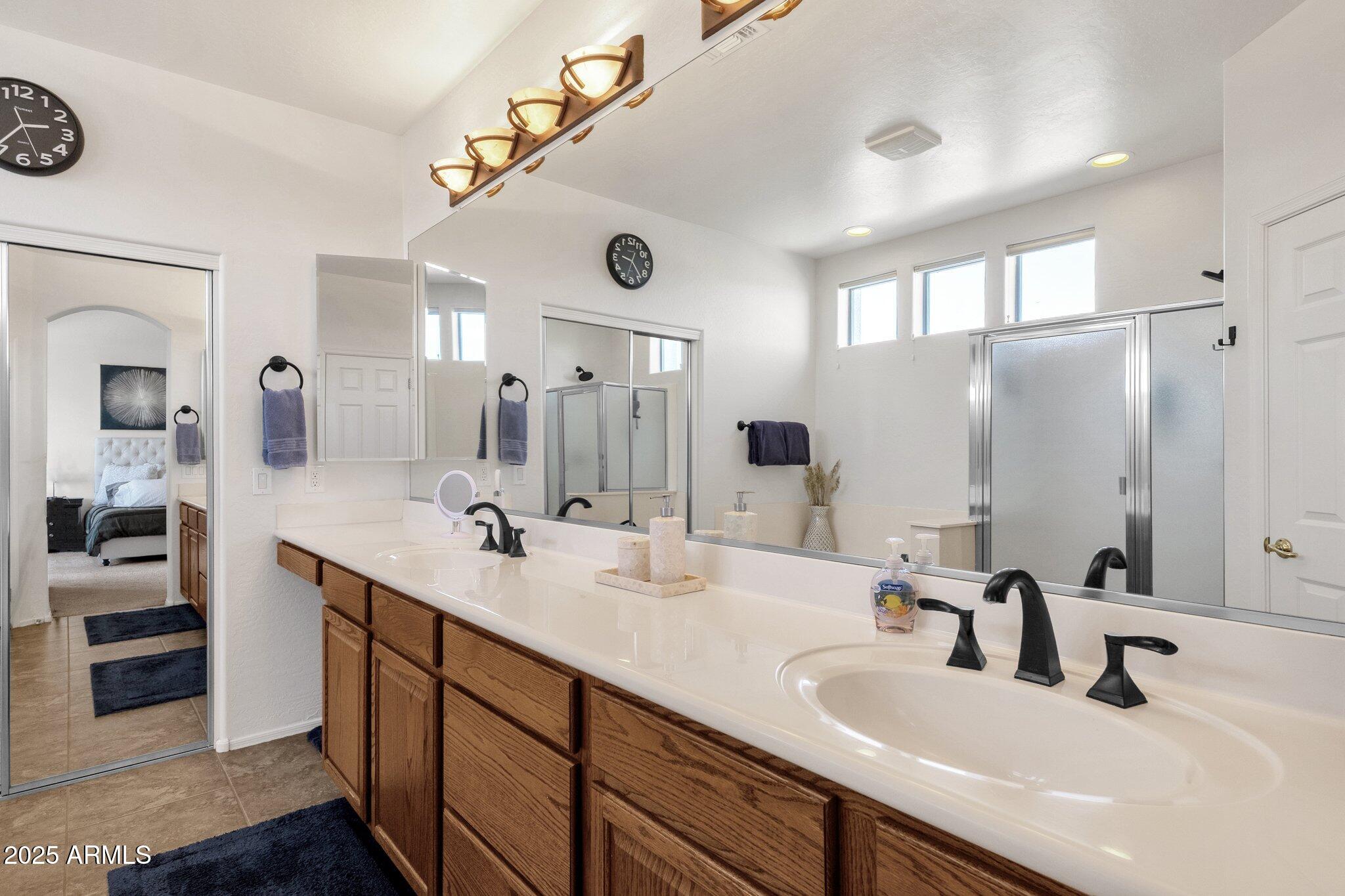 2417 West Apache Rain Road Phoenix, AZ 85085 - Photo 25 of 41 a bathroom with double vanity sinks and a mirror