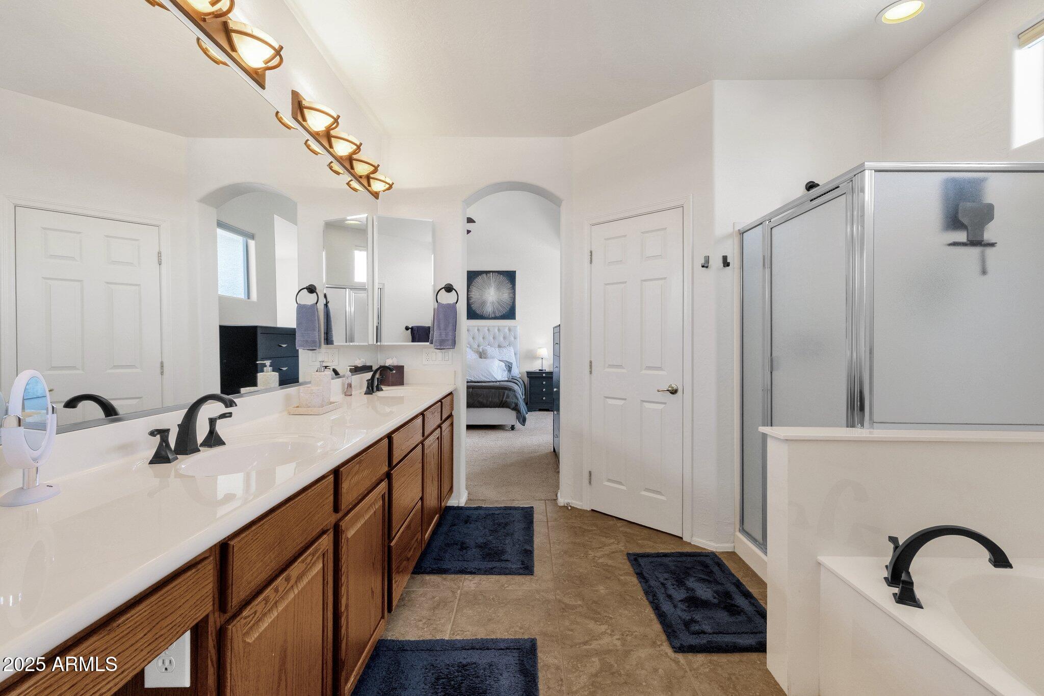 2417 West Apache Rain Road Phoenix, AZ 85085 - Photo 26 of 41 a spacious bathroom with a double vanity sink mirror and shower