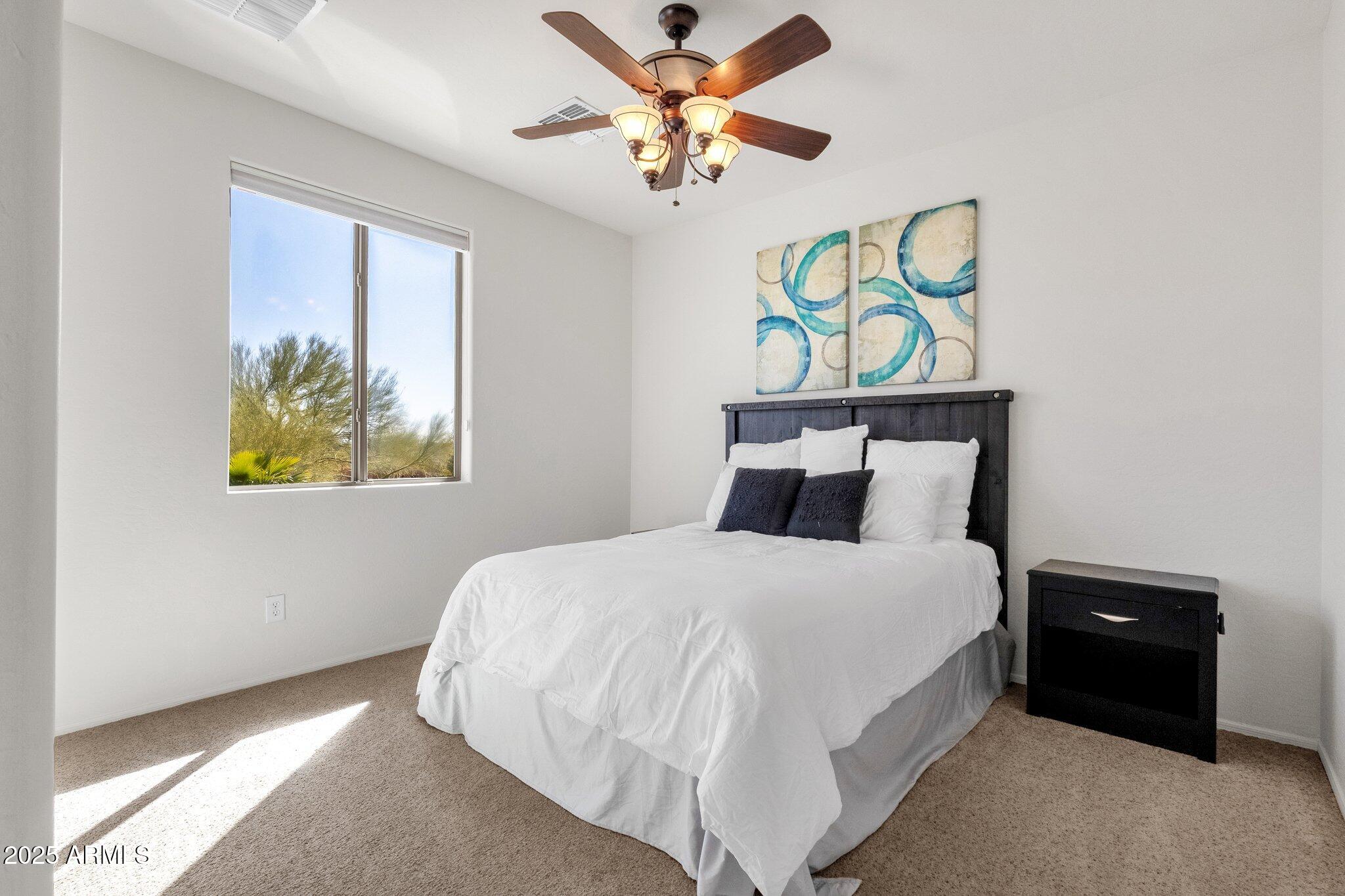 2417 West Apache Rain Road Phoenix, AZ 85085 - Photo 31 of 41 a bedroom with a bed and painting on the wall