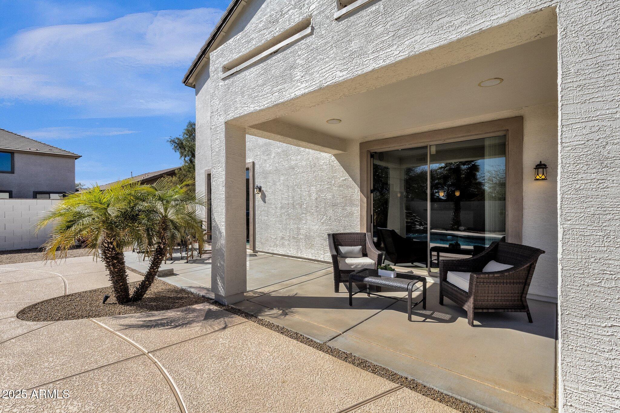 2417 West Apache Rain Road Phoenix, AZ 85085 - Photo 32 of 41 a building outdoor space with patio furniture and potted plants