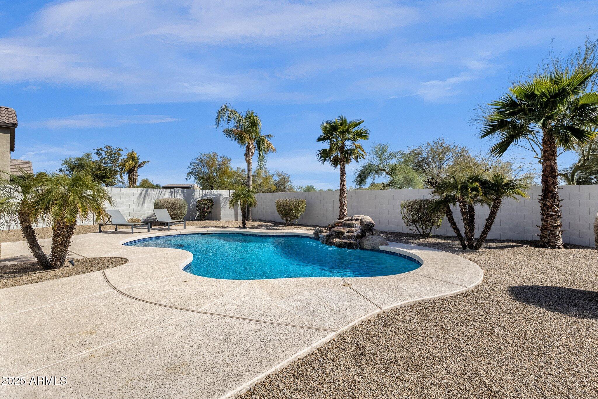 2417 West Apache Rain Road Phoenix, AZ 85085 - Photo 34 of 41 a swimming pool with outdoor seating and house
