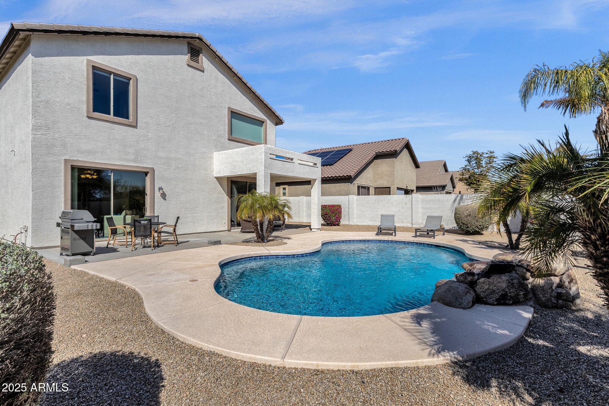 2417 West Apache Rain Road Phoenix, AZ 85085 - Photo 35 of 41 a view of a house with swimming pool and sitting area