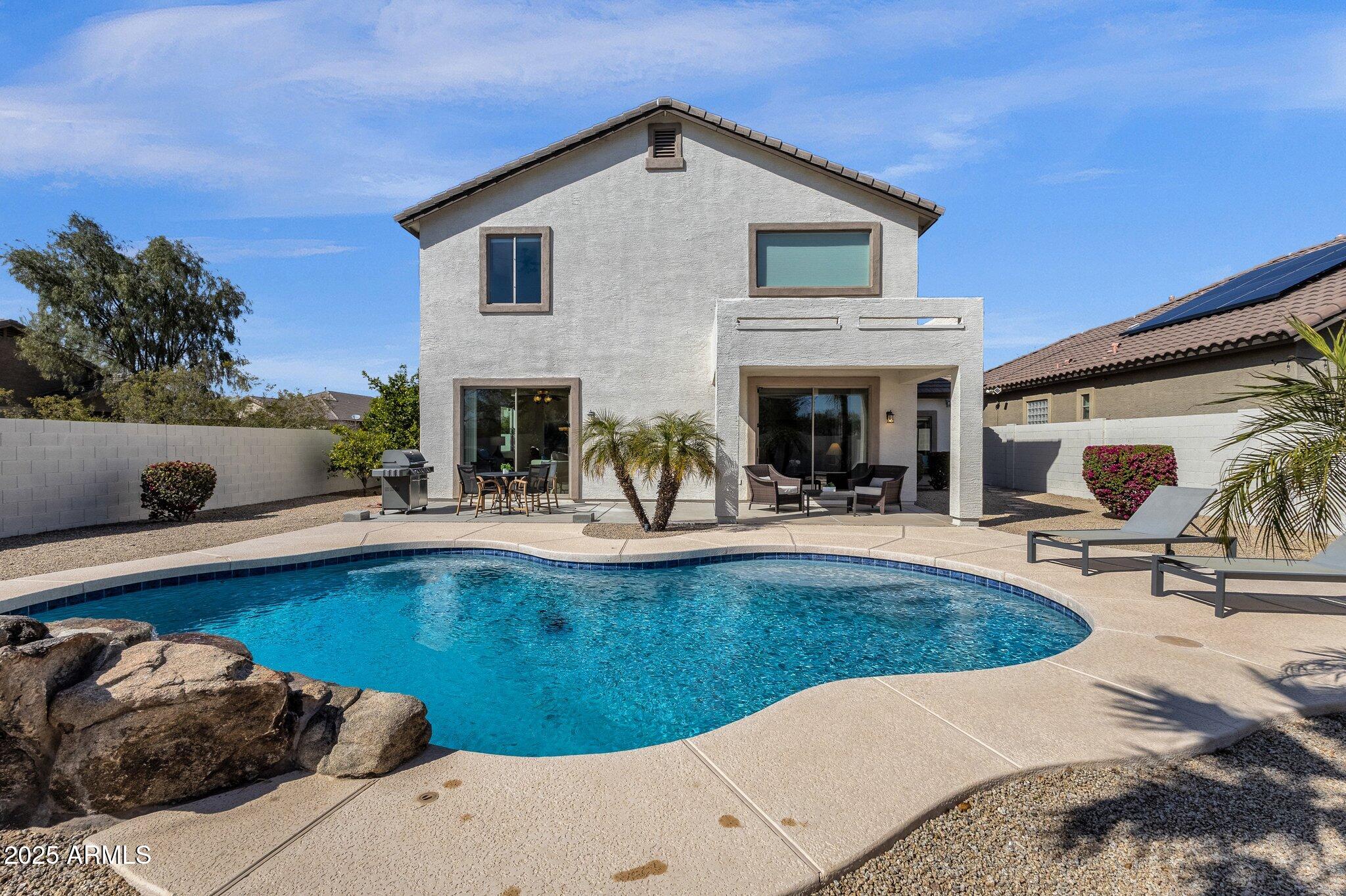 2417 West Apache Rain Road Phoenix, AZ 85085 - Photo 38 of 41 a view of a house with swimming pool and sitting area