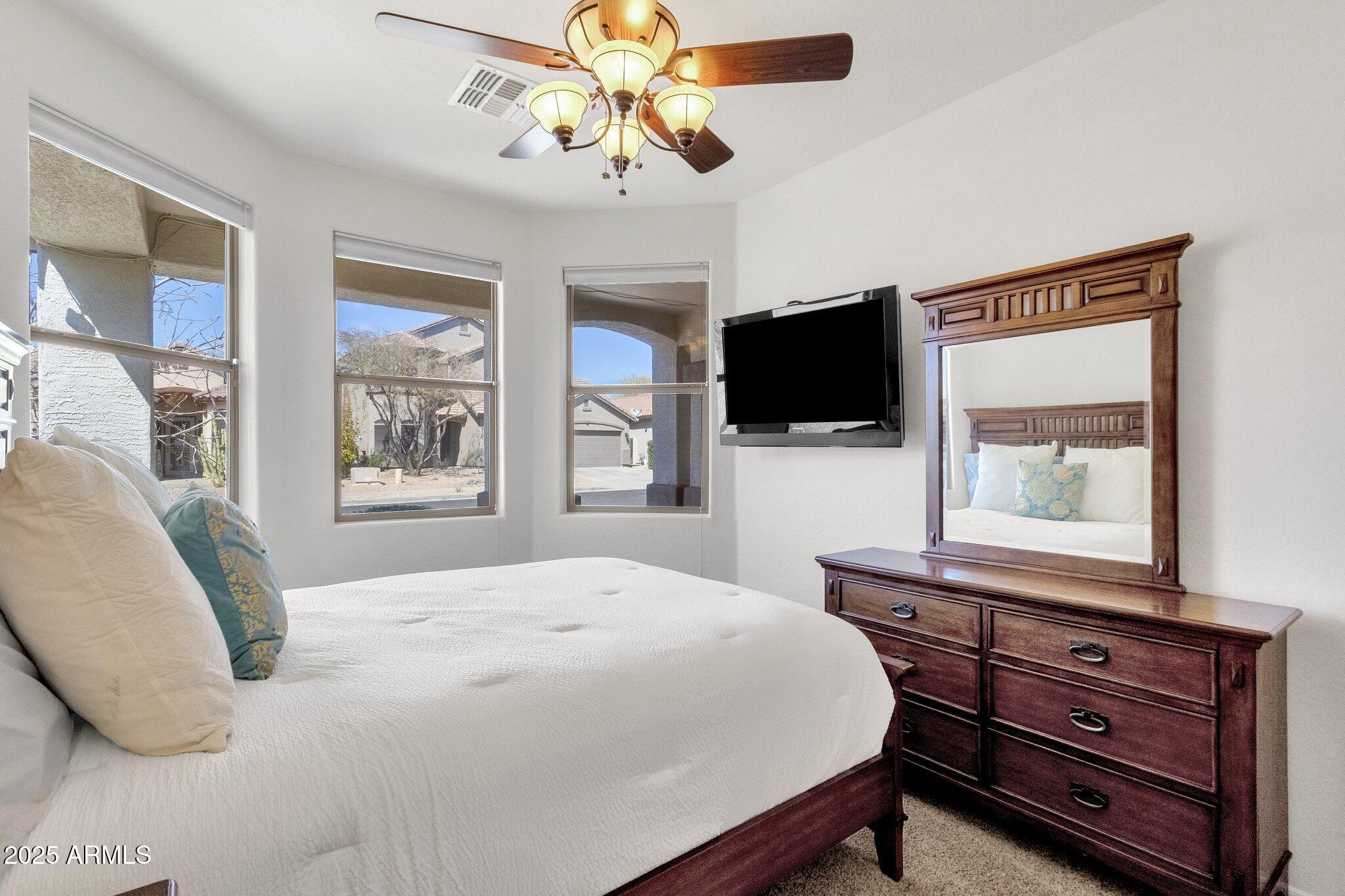 2417 West Apache Rain Road Phoenix, AZ 85085 - Photo 6 of 41 a bedroom with a bed and a flat screen tv