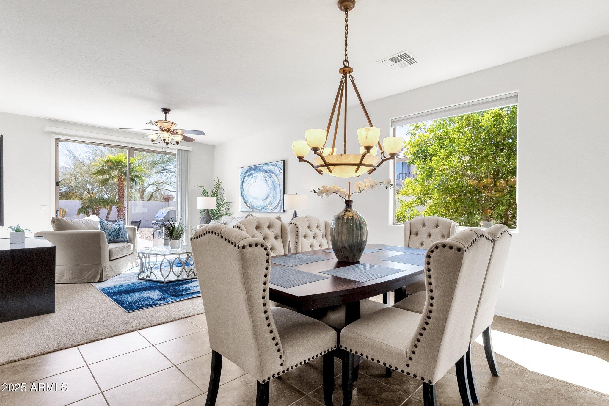 2417 West Apache Rain Road Phoenix, AZ 85085 - Photo 7 of 41 a view of a dining room with furniture wooden floor and chandelier