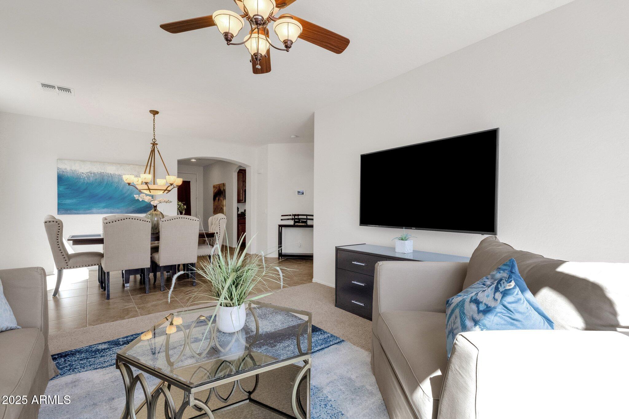 2417 West Apache Rain Road Phoenix, AZ 85085 - Photo 9 of 41 a living room with furniture and a flat screen tv