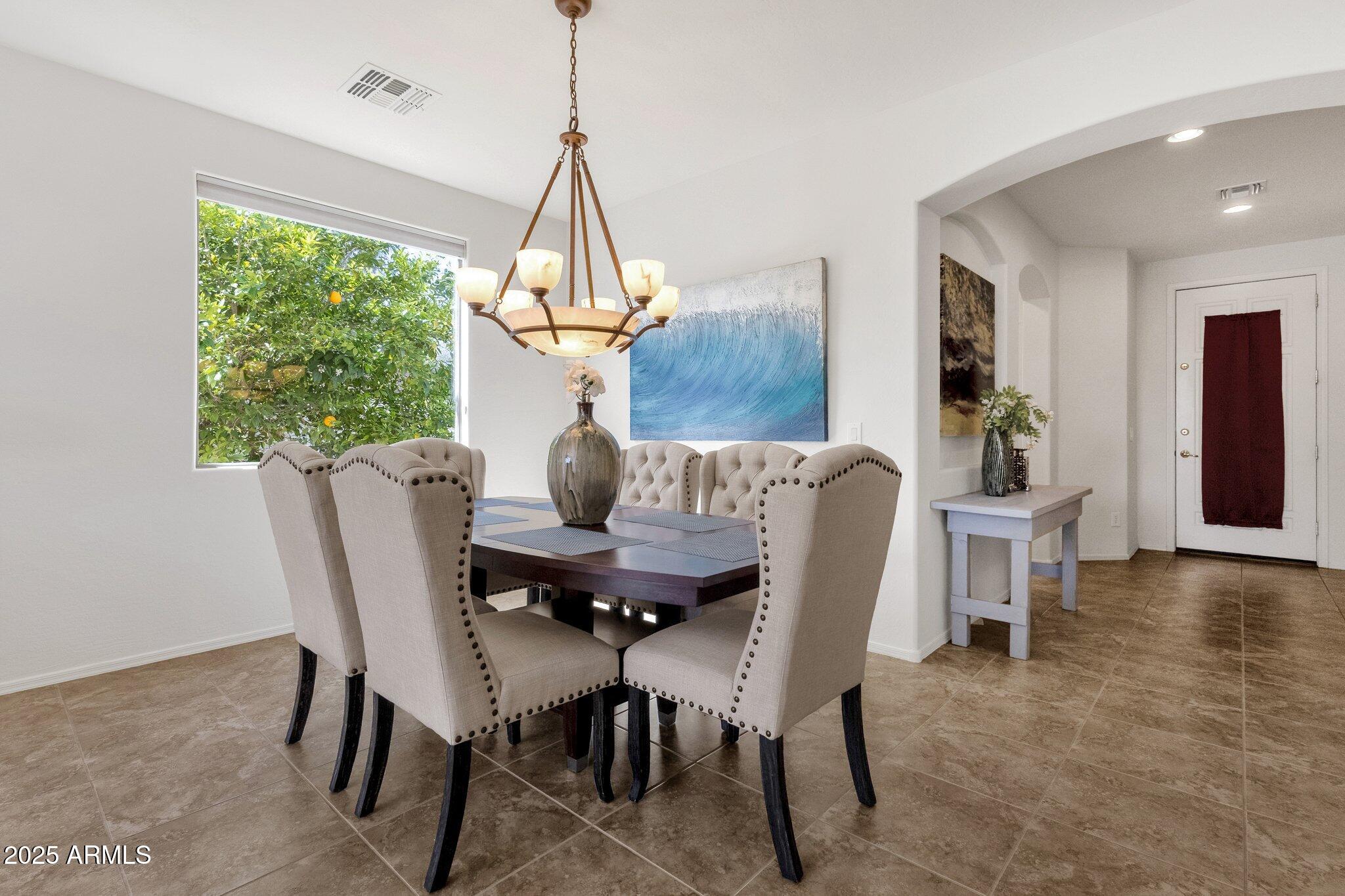 2417 West Apache Rain Road Phoenix, AZ 85085 - Photo 10 of 41 a view of a dining room with furniture window and wooden floor