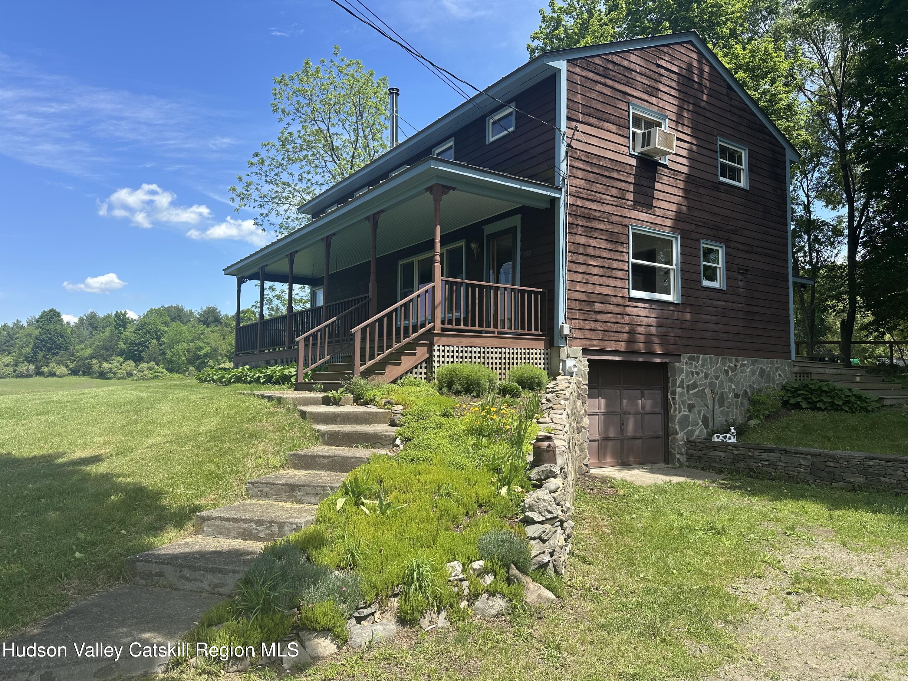 1492 County Road Copake, NY 12516 - Photo 31 of 34 a backyard of a house with a garden and deck