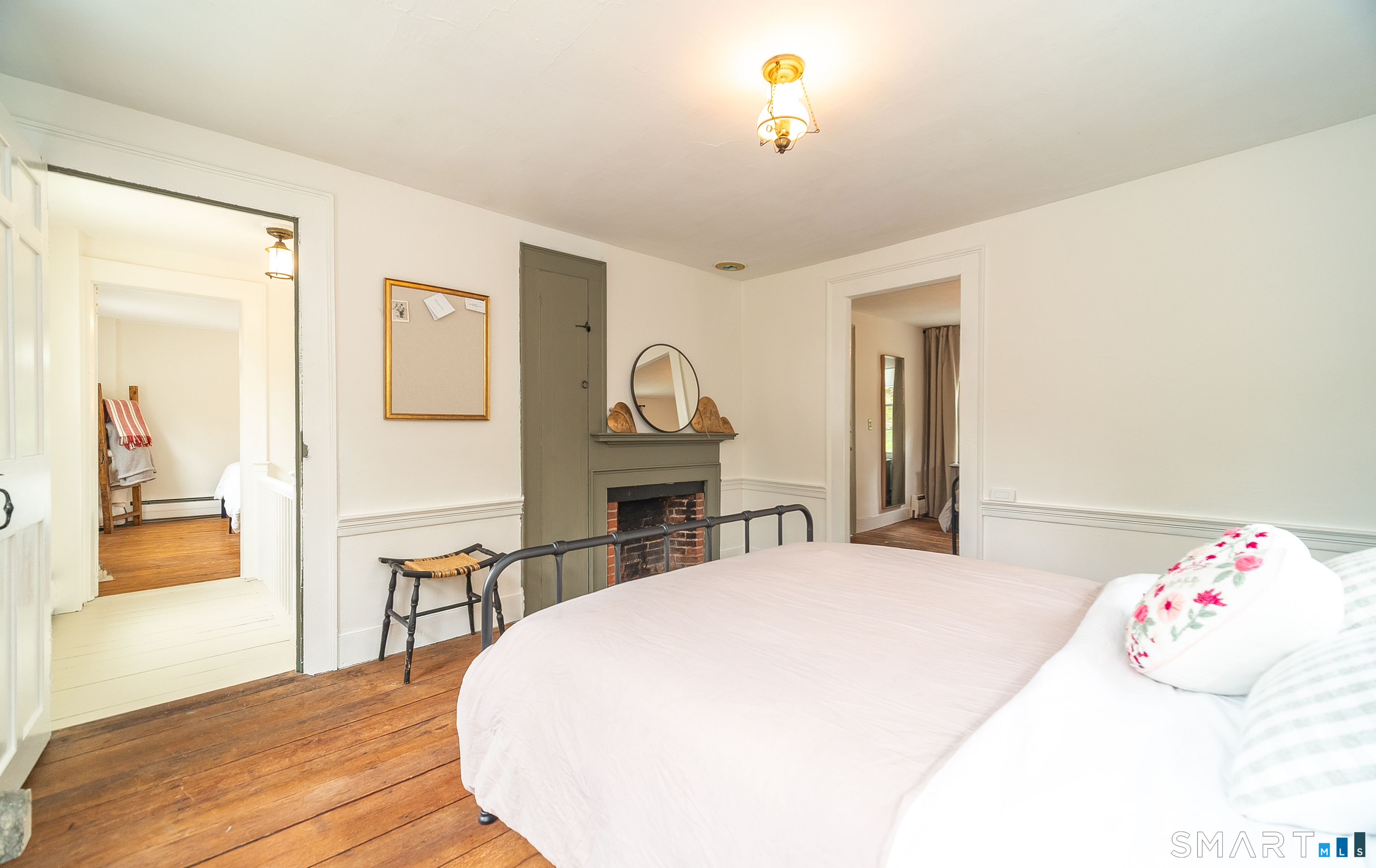 230 Killingworth Road Haddam, CT 06441 - Photo 23 of 36 a bedroom with a bed and a chandelier