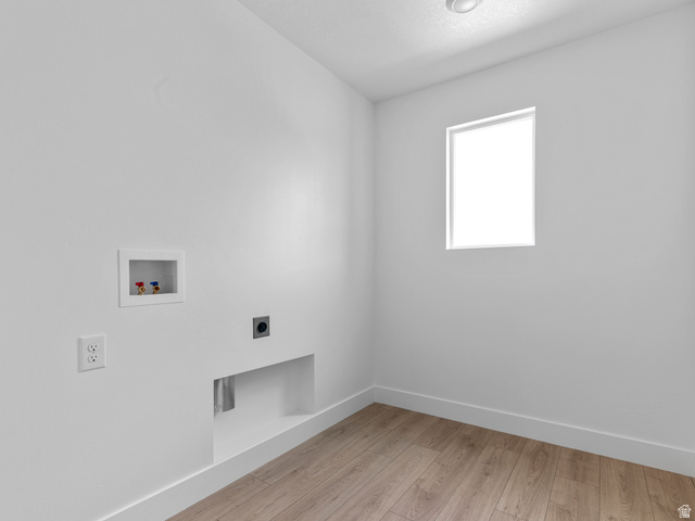 738 West 2840 South, Unit 6 Nibley, UT 84321 - Photo 20 of 23 Dedicated laundry space featuring wood-finish flooring, a bright window, and essential hookups for appliances