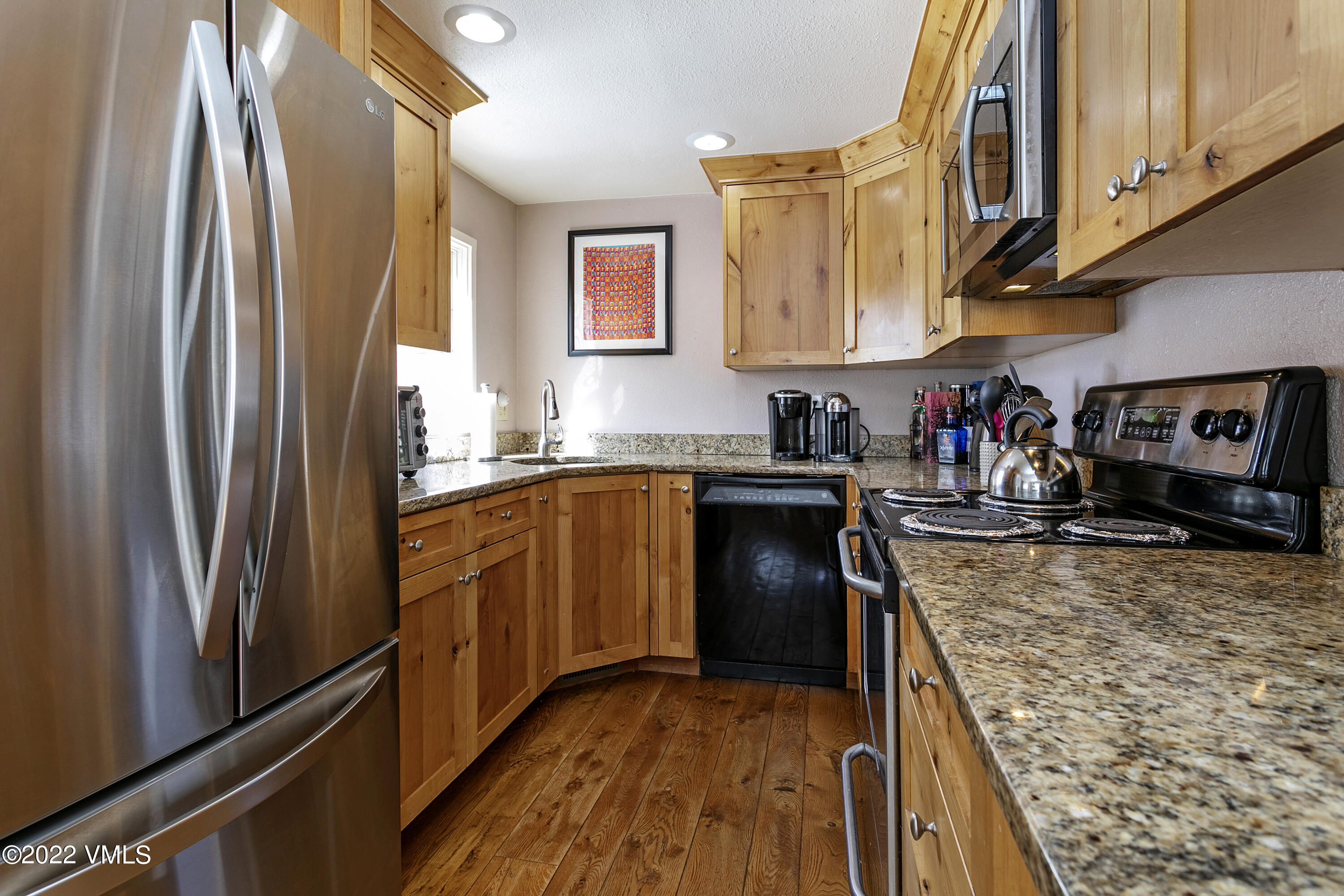 1614 Buffehr Creek Road, Unit A19 Vail, CO 81657 - Photo 8 of 23 a kitchen with stainless steel appliances granite countertop a refrigerator a stove and a sink