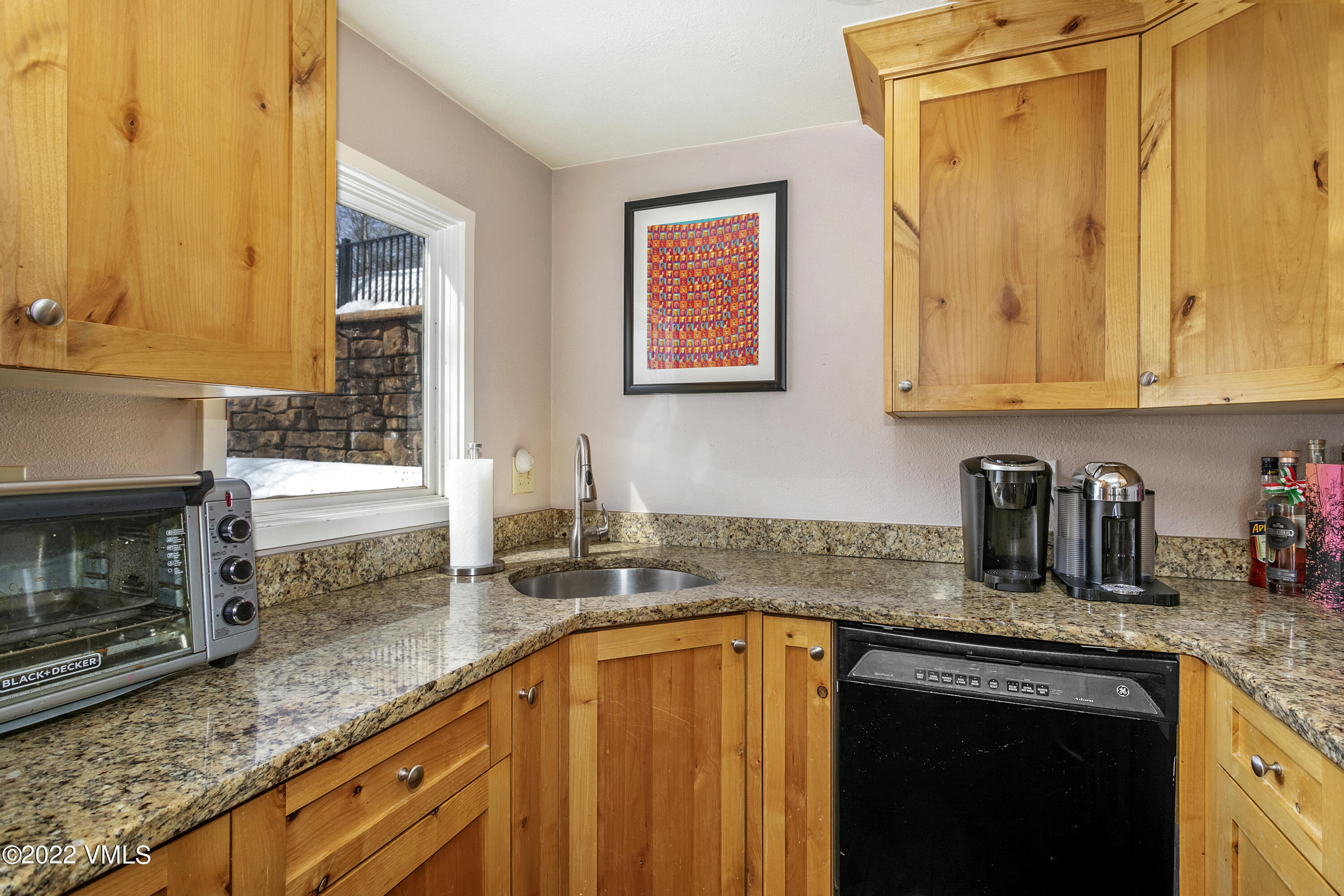 1614 Buffehr Creek Road, Unit A19 Vail, CO 81657 - Photo 9 of 23 a kitchen with granite countertop a sink a stove and cabinets
