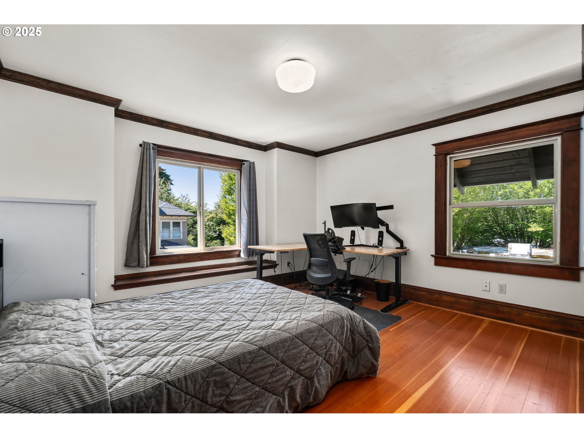 928 Southeast 18th Avenue Portland, OR 97214 - Photo 28 of 47 a bedroom with a bed and wooden floor