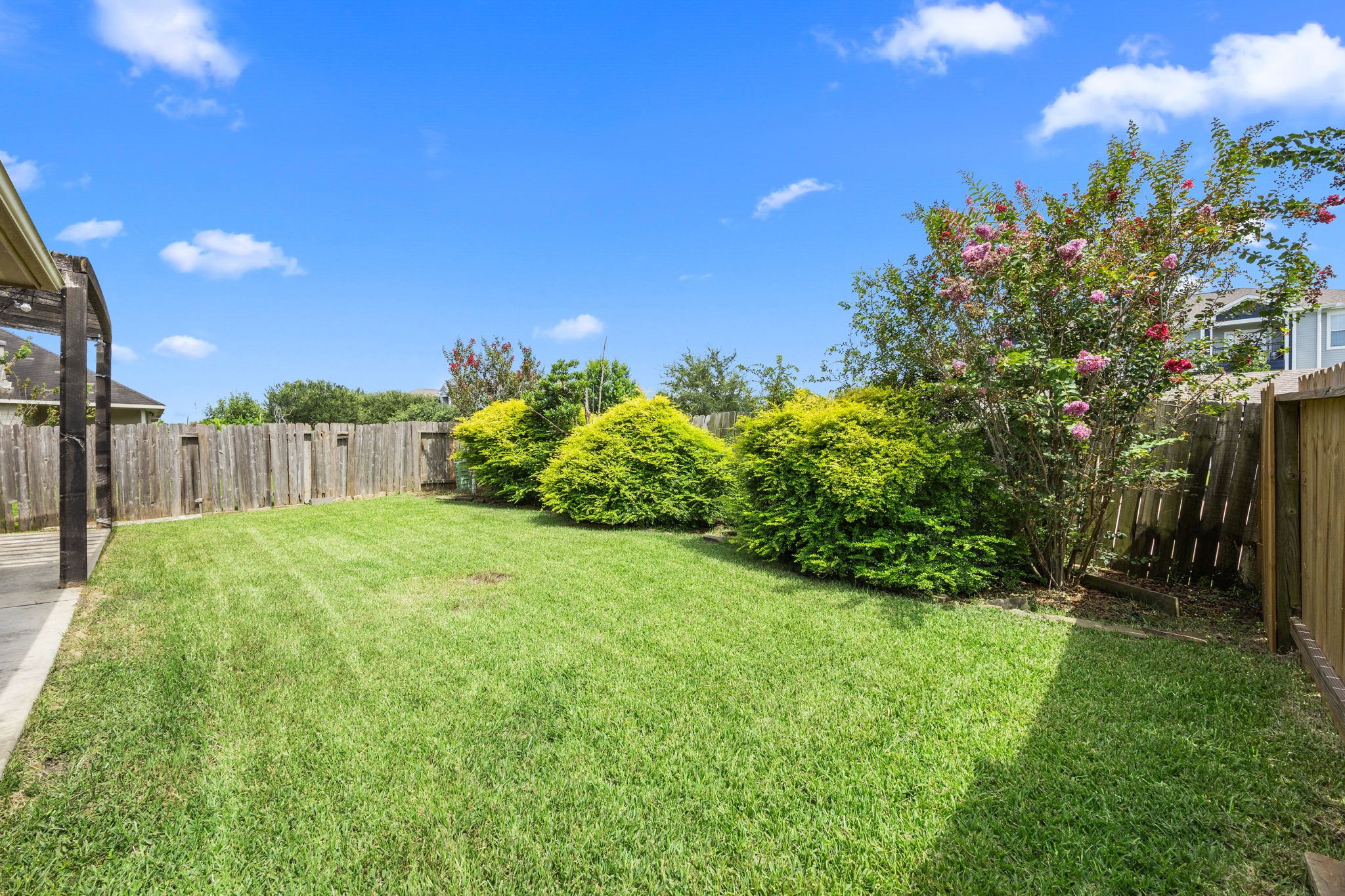3606 Canvasback Lane Houston, TX 77047 - Photo 26 of 29 Large, private backyard with lush landscaping, mature shrubs, and ample room to add a playset, garden, or future pool.