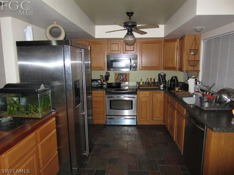 6197 Park Road Fort Myers, FL 33908 - Photo 4 of 11 a kitchen with granite countertop stainless steel appliances and counter space