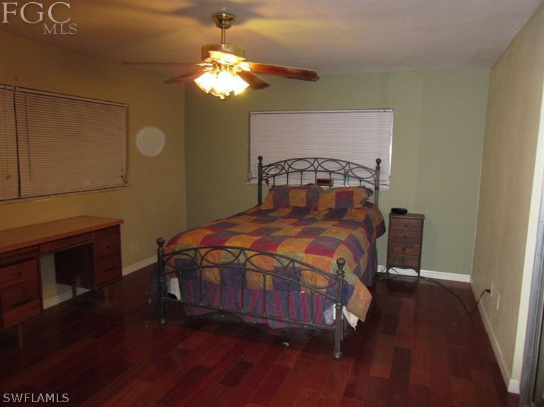6197 Park Road Fort Myers, FL 33908 - Photo 9 of 11 a bedroom with a bed a fireplace and a chandelier