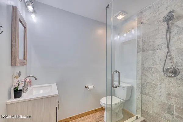 a bathroom with a sink toilet and shower