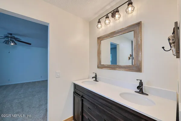 a bathroom with a sink a mirror and vanity