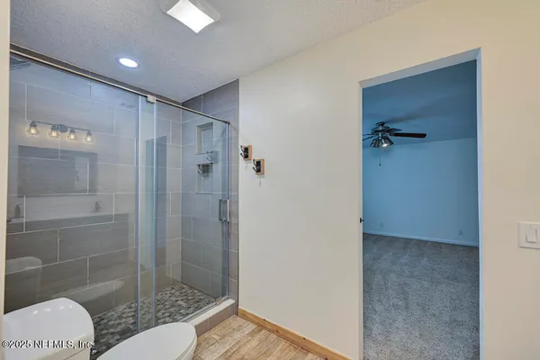 a bathroom with a shower and a toilet