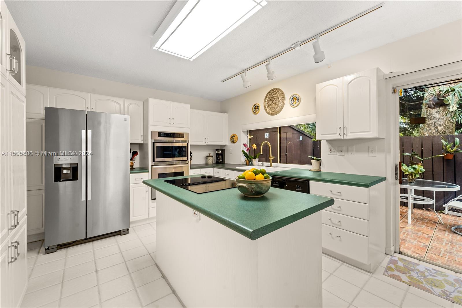 8636 Southwest 94th Street Miami, FL 33156 - Photo 11 of 29 a kitchen with a sink a stove and refrigerator