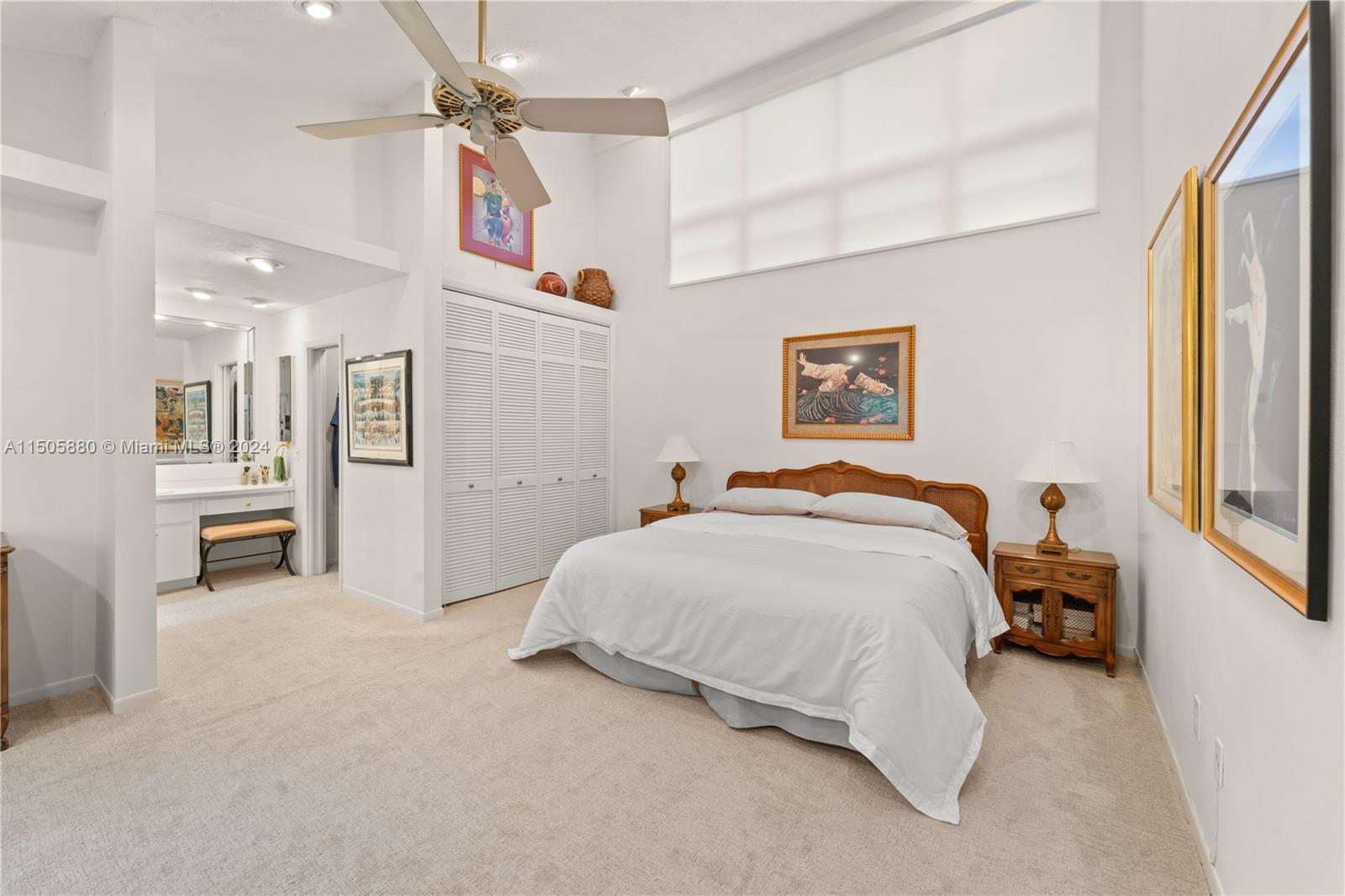 8636 Southwest 94th Street Miami, FL 33156 - Photo 15 of 29 a spacious bedroom with a bed and a chandelier