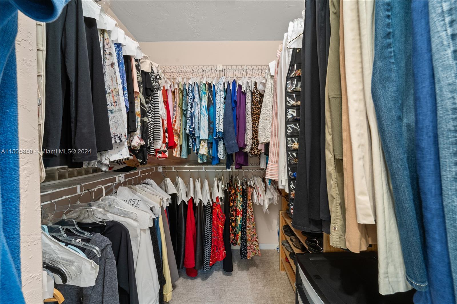 8636 Southwest 94th Street Miami, FL 33156 - Photo 19 of 29 a view of walk in closet with clothes