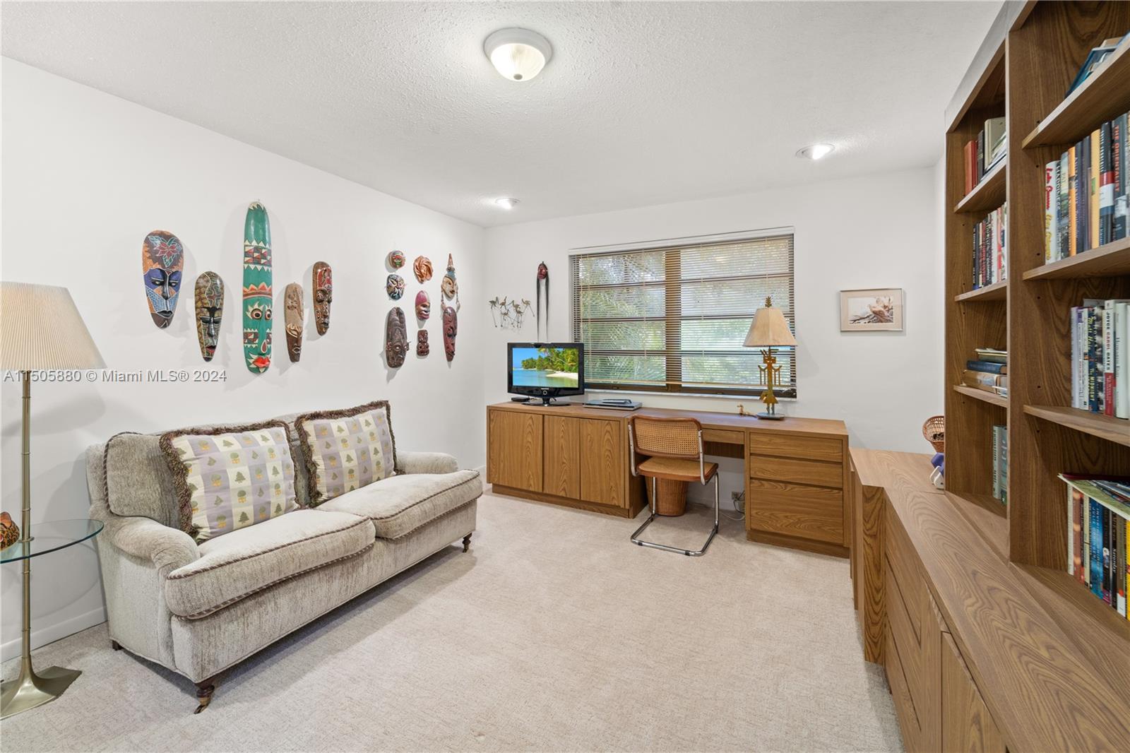 8636 Southwest 94th Street Miami, FL 33156 - Photo 20 of 29 a living room with furniture and a book shelf