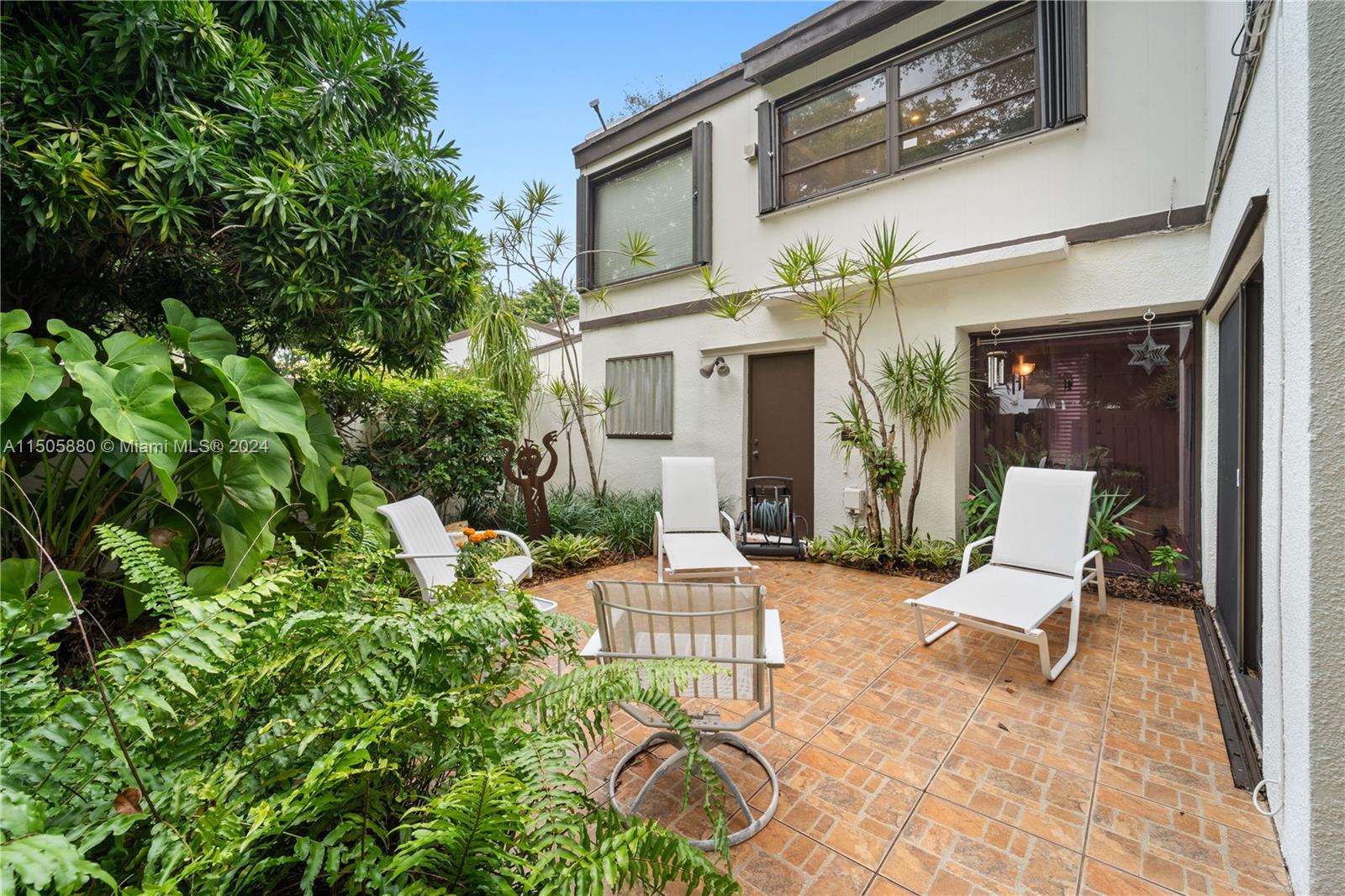 8636 Southwest 94th Street Miami, FL 33156 - Photo 24 of 29 a view of a patio with chairs and potted plants