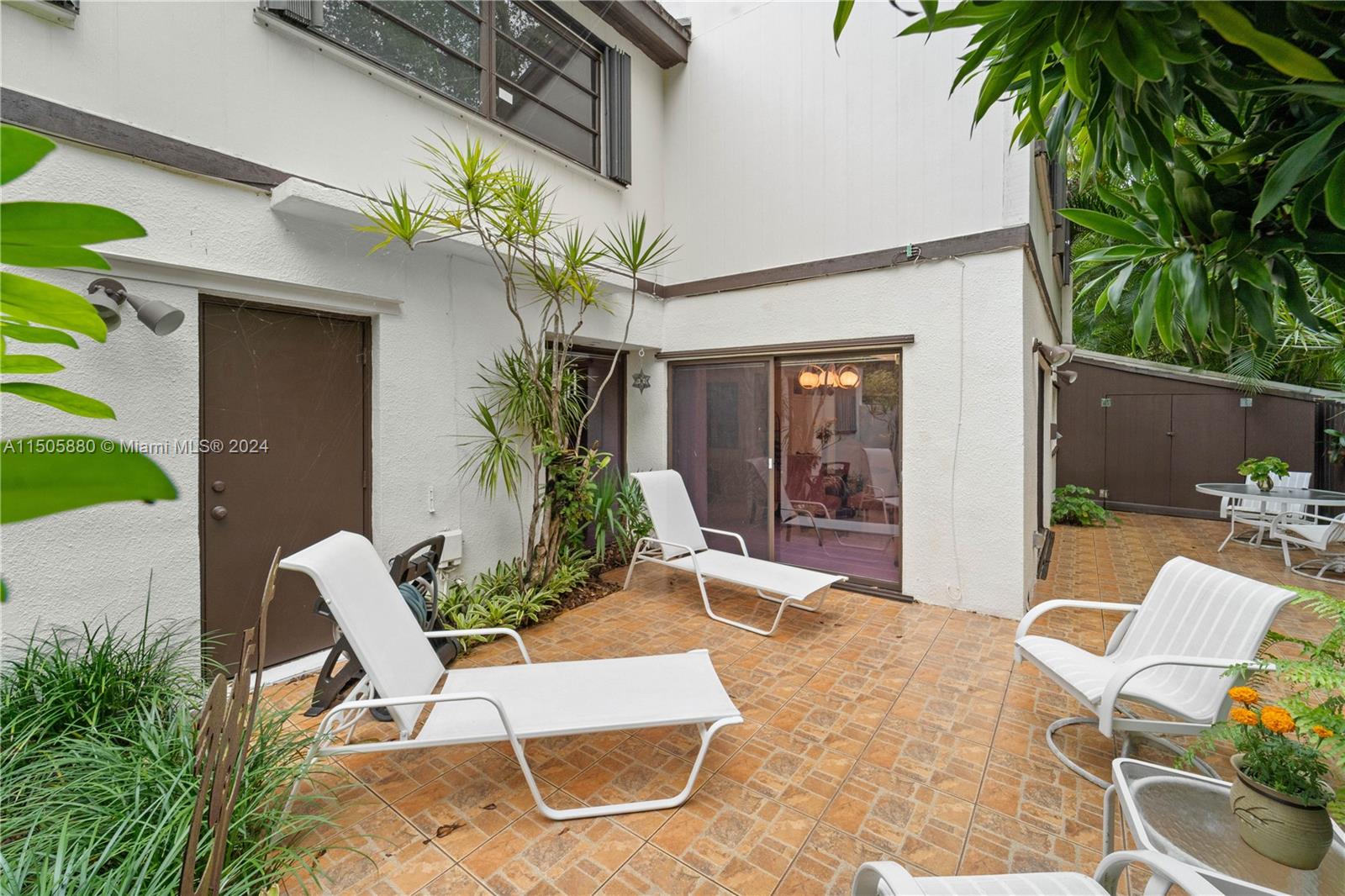 8636 Southwest 94th Street Miami, FL 33156 - Photo 25 of 29 a view of a chair and table in backyard of the house