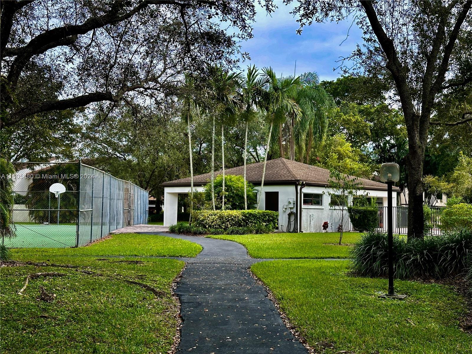 8636 Southwest 94th Street Miami, FL 33156 - Photo 29 of 29 a front view of a house with yard and green space