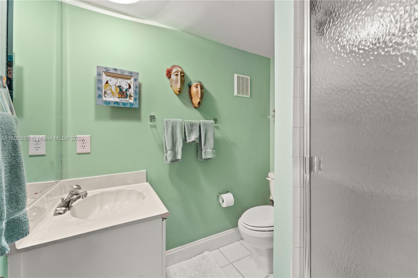 8636 Southwest 94th Street Miami, FL 33156 - Photo 9 of 29 a bathroom with a toilet sink and mirror