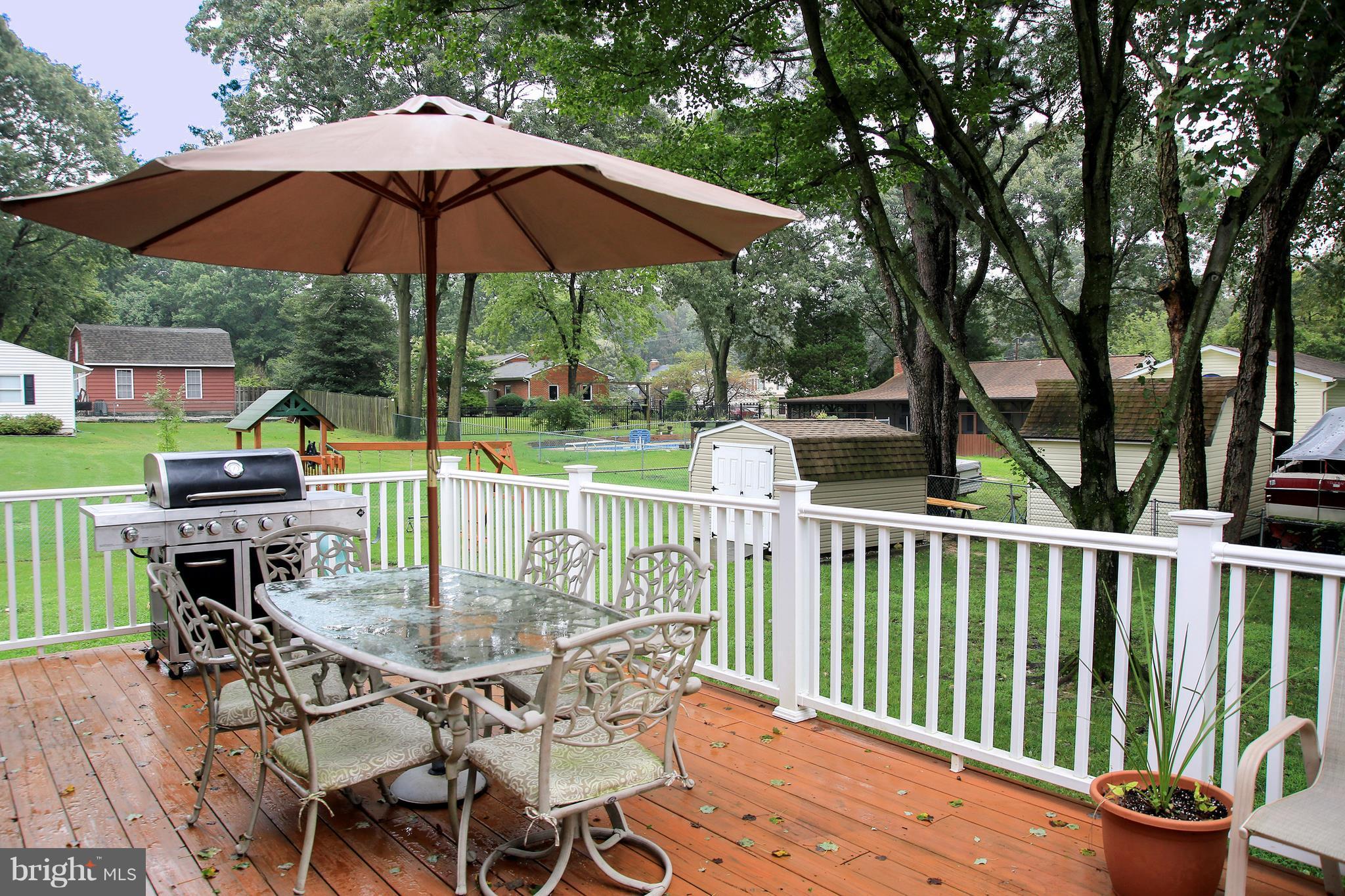 765 Evergreen Road Severn, MD 21144 - Photo 20 of 23 a view of a chairs and table under an umbrella