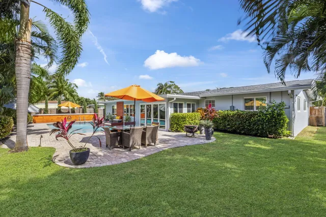 an aerial view of a house with a yard and lake view