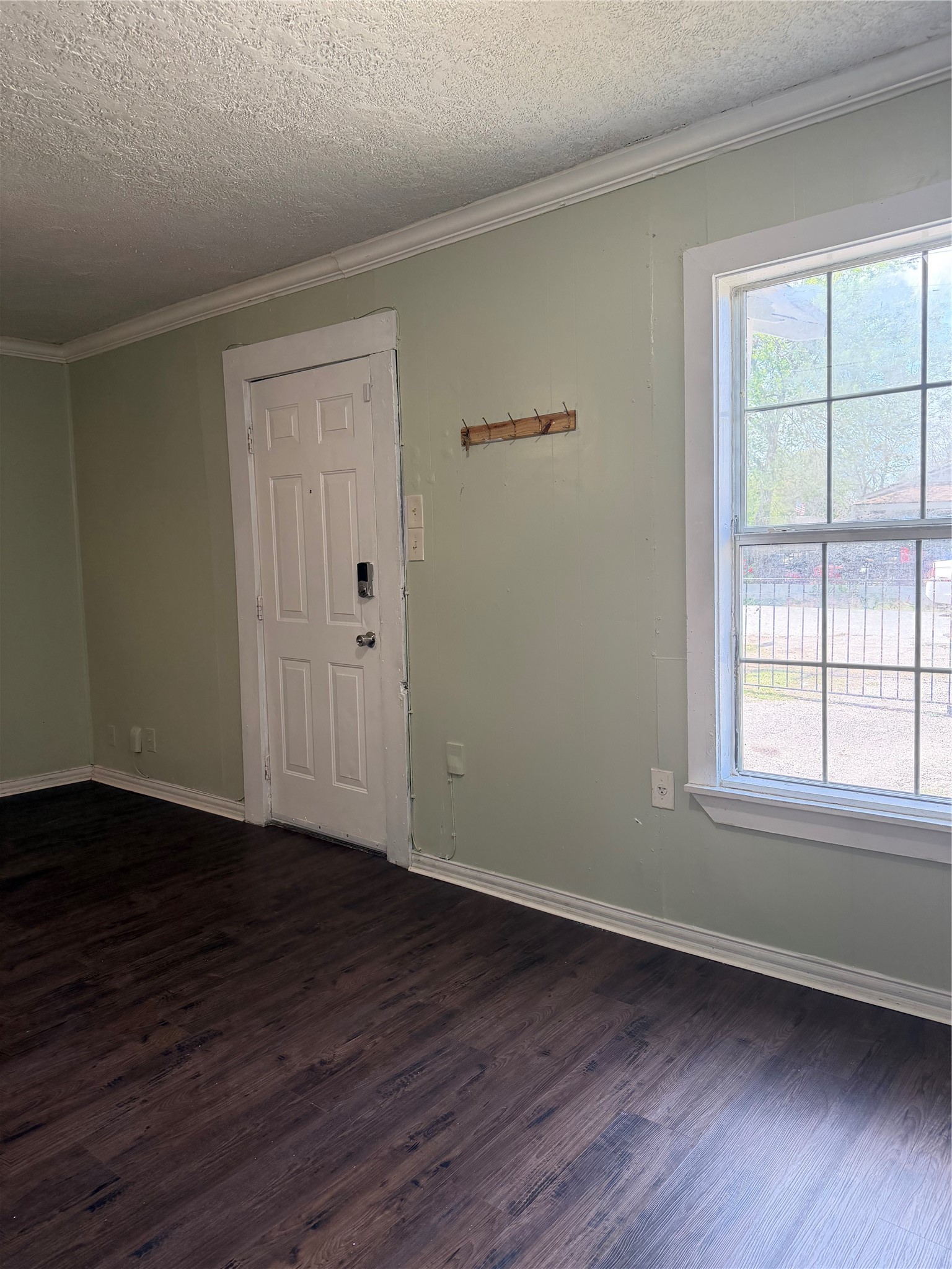 11914 Anchick Street Houston, TX 77076 - Photo 15 of 17 a view of an empty room with wooden floor and a window