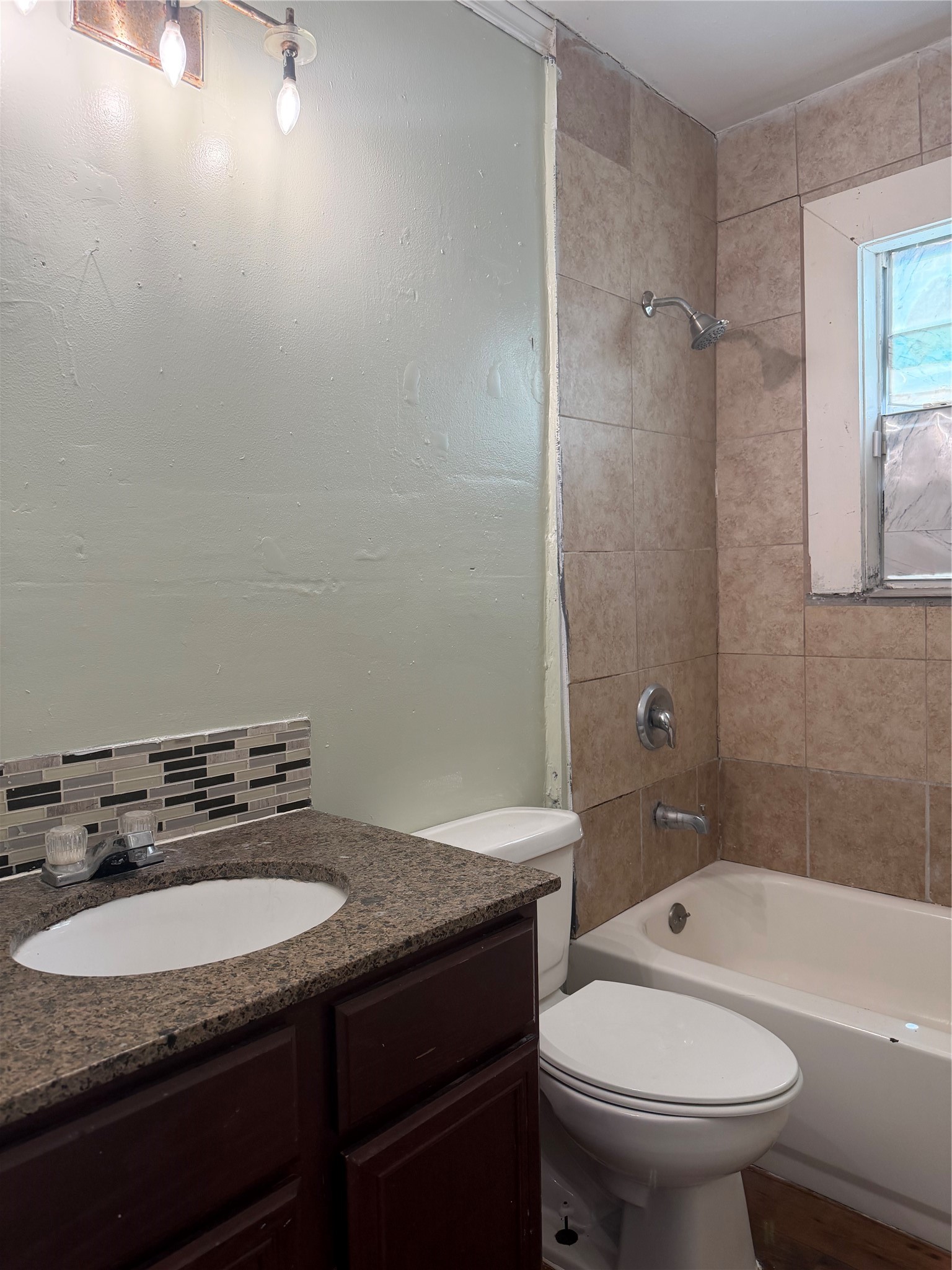 11914 Anchick Street Houston, TX 77076 - Photo 6 of 17 a bathroom with a sink toilet vanity and shower