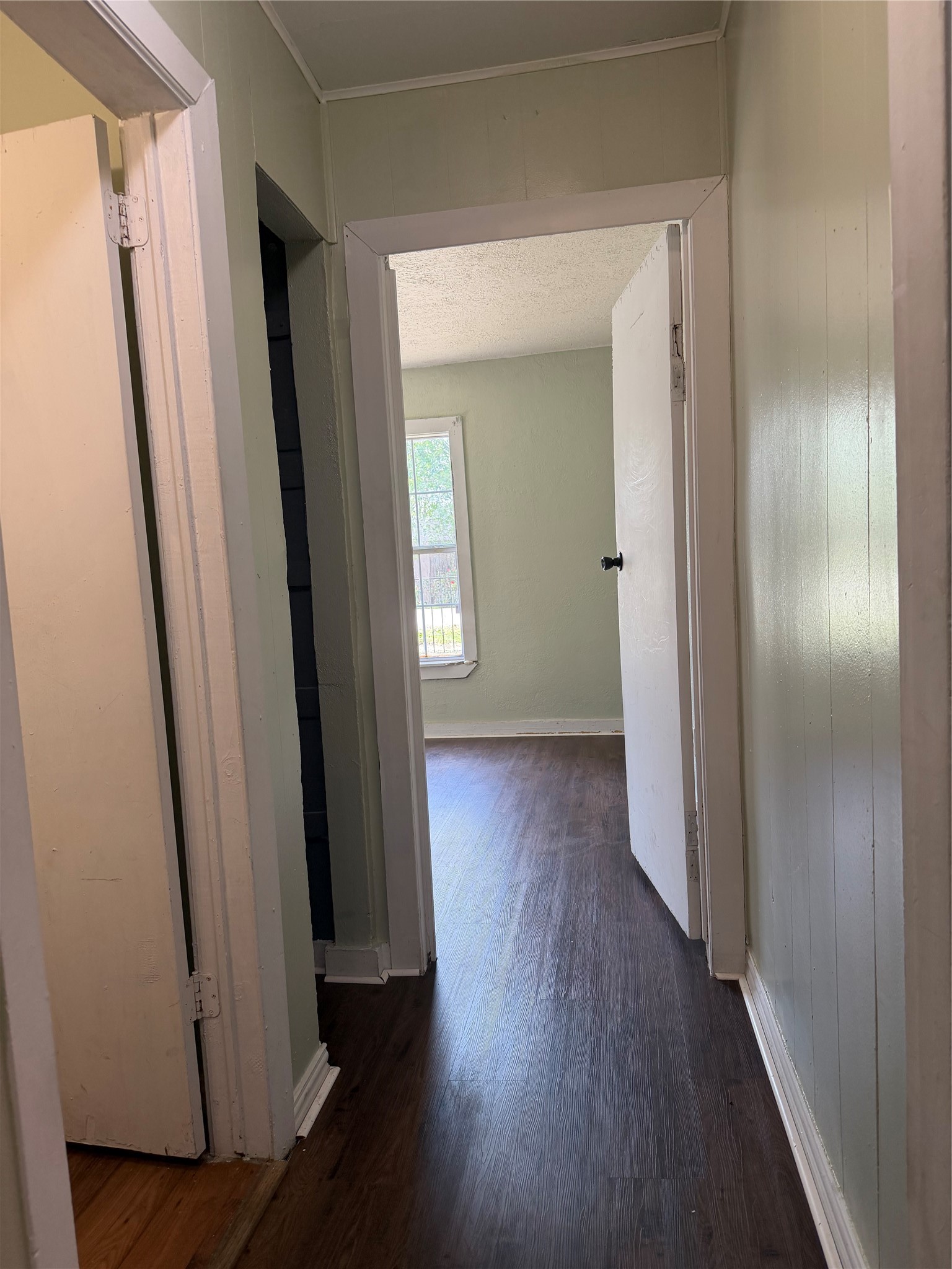 11914 Anchick Street Houston, TX 77076 - Photo 9 of 17 a view of a hallway with wooden floor