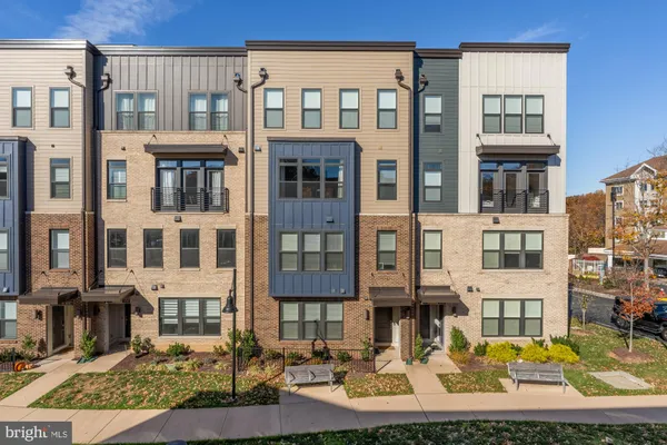 a front view of a residential apartment building with a yard