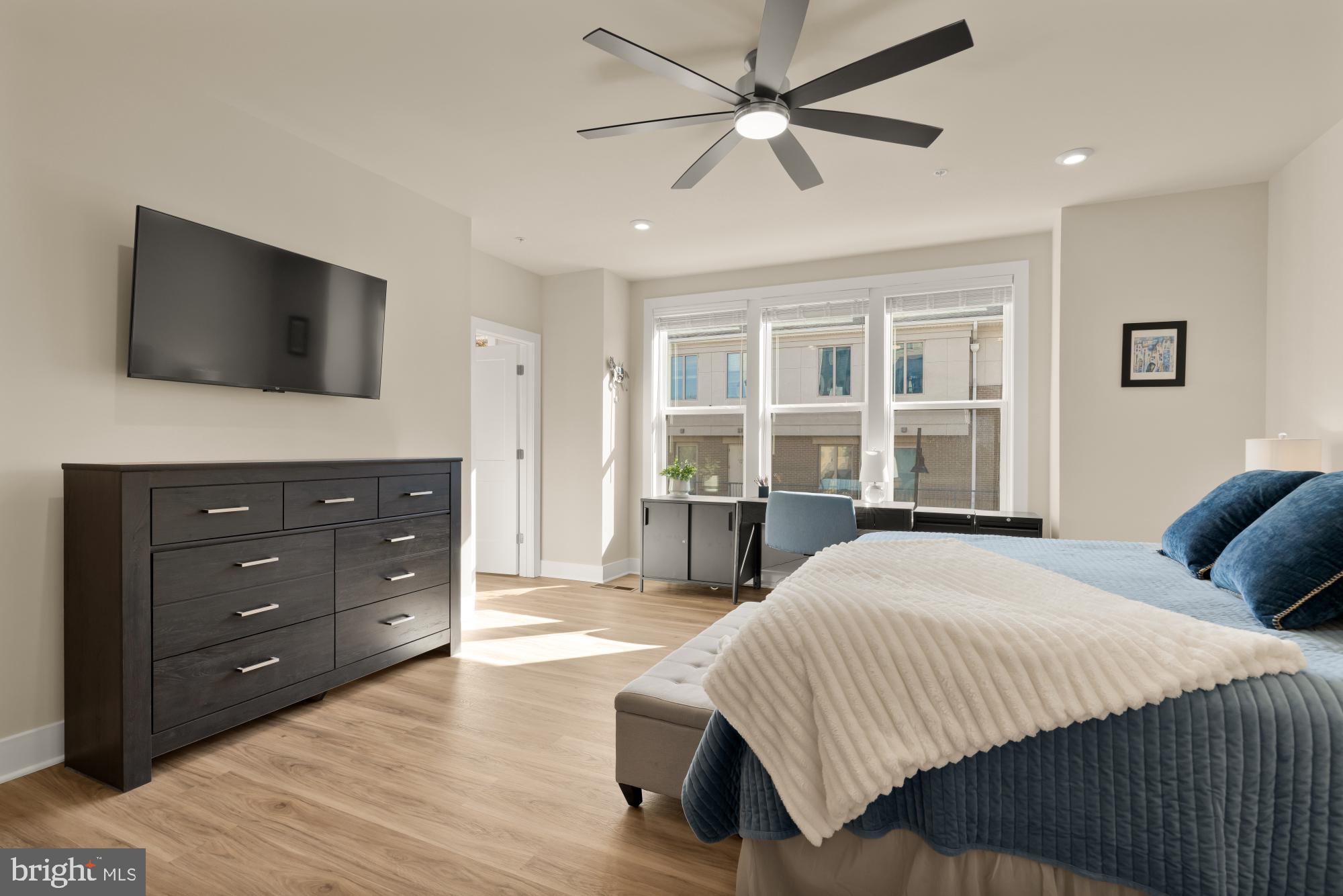 1704 Bandit Loop, Unit 20A Reston, VA 20190 - Photo 10 of 32 a spacious bedroom with a bed and a flat screen tv