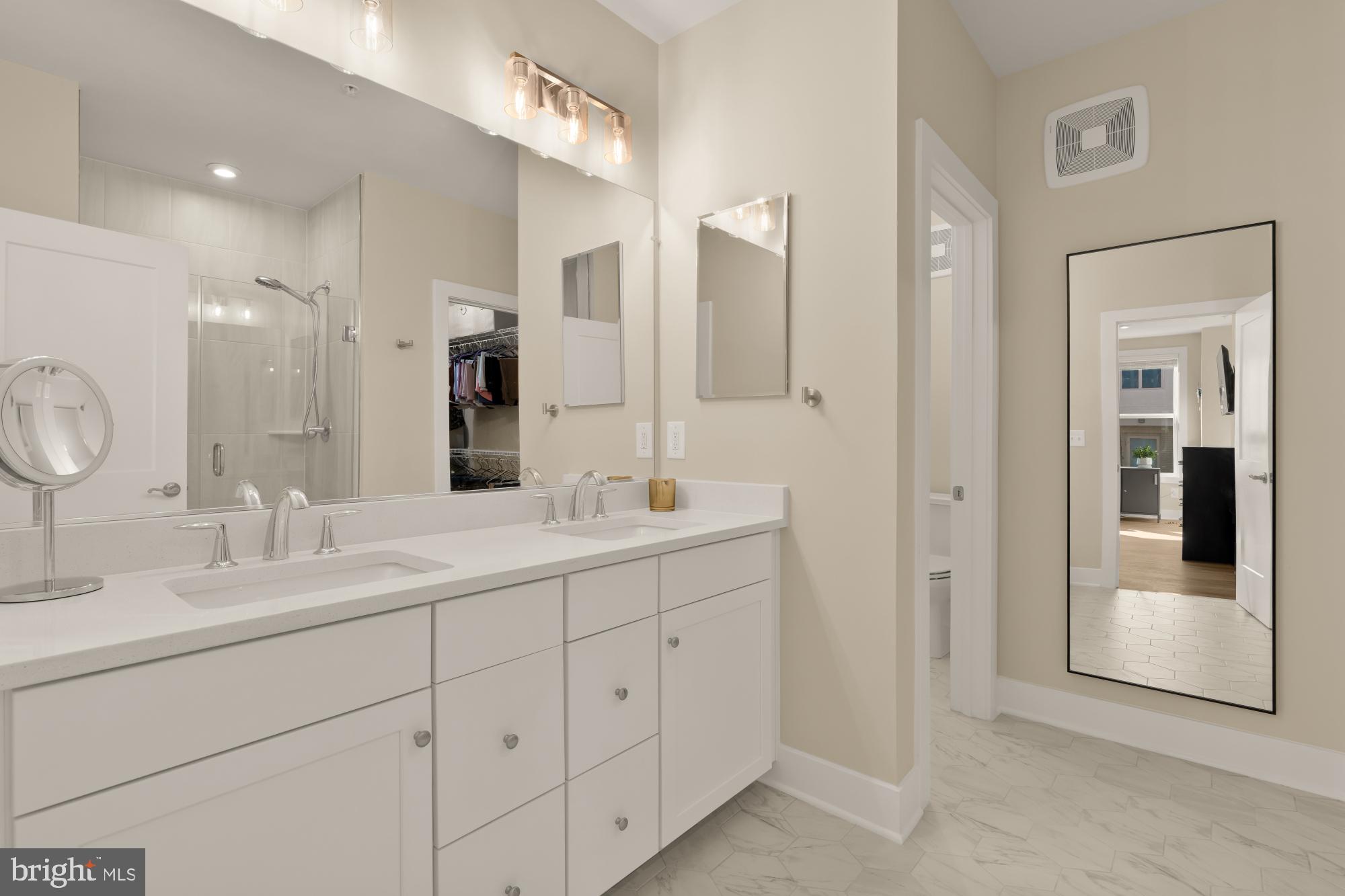 1704 Bandit Loop, Unit 20A Reston, VA 20190 - Photo 11 of 32 a bathroom with a double vanity sink mirror and next to a white cabinet